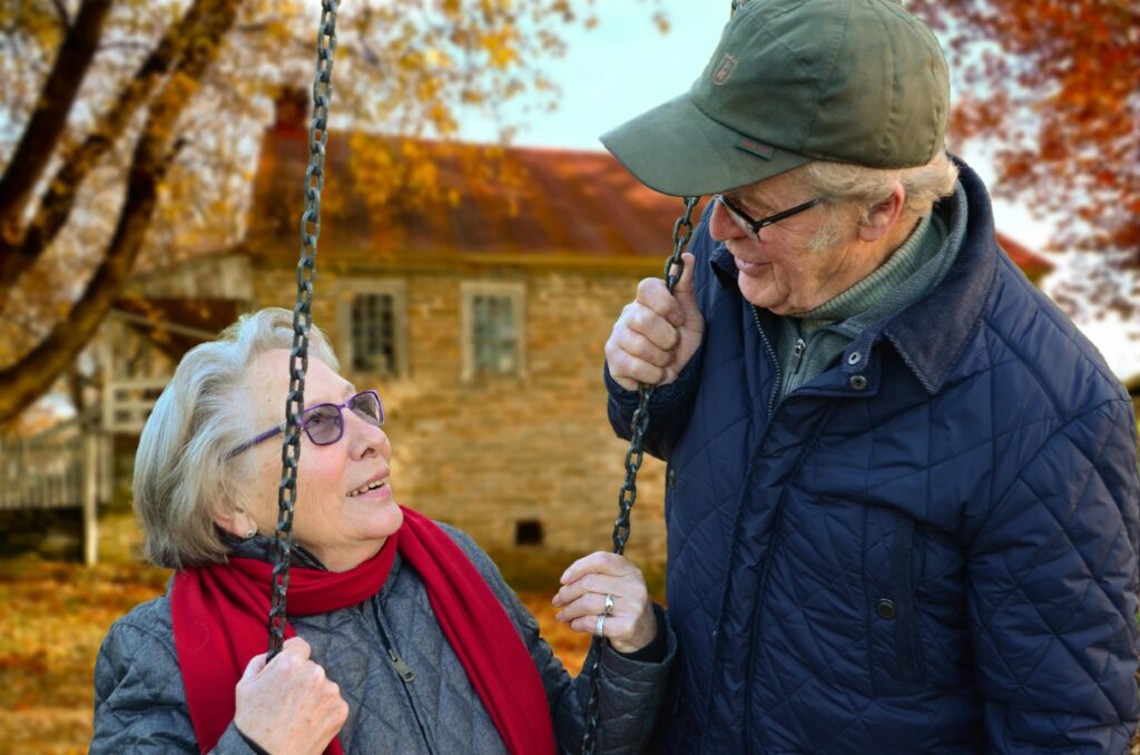 old-people-couple-together-connected-34761 Man Standing Beside Woman on Swing