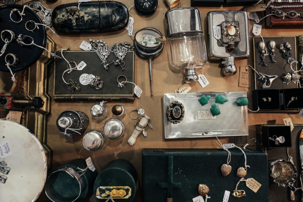 Aerial view of a vintage jewelry and antiques market display with various items for sale.